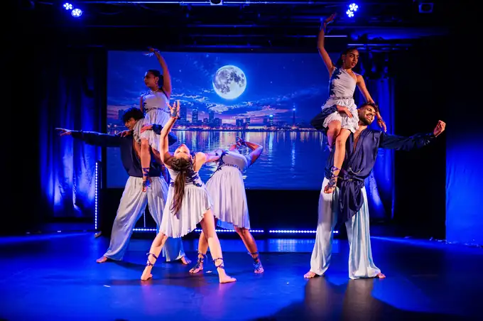 Dancers lifted overhead in a symmetrical formation during Act One